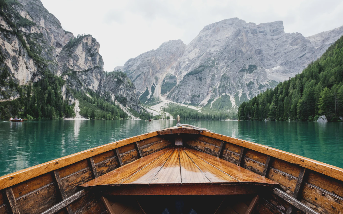Wooden boat on a turquoise mountain lake