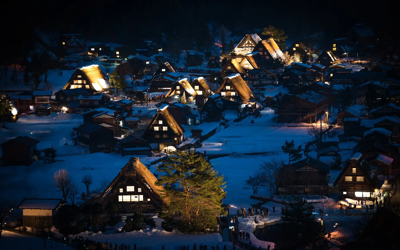 Snow-covered thatched farmhouses in the village of Shirakawa-go at night