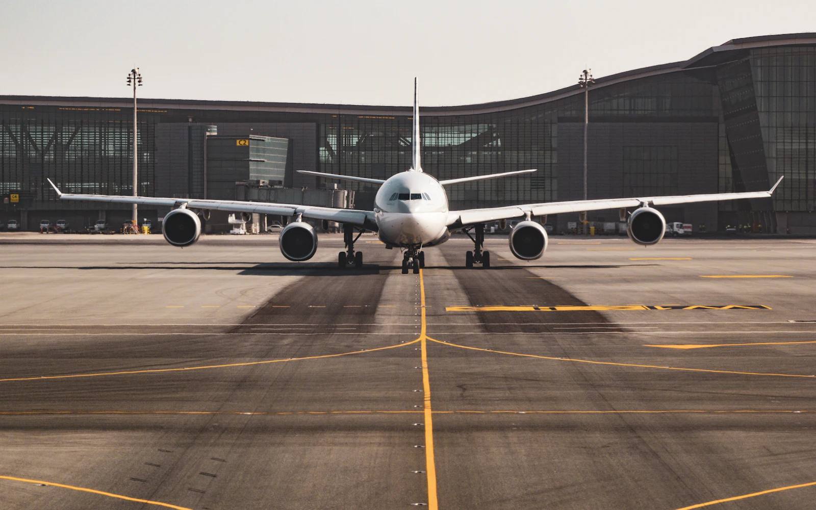 Passenger jet parked at an airport gate on a clear day