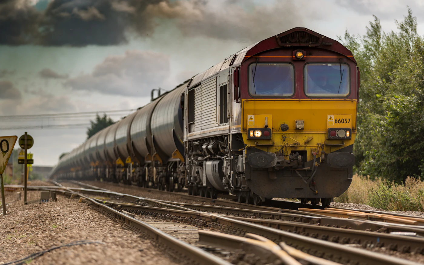 Freight train on a railway track beside a signal