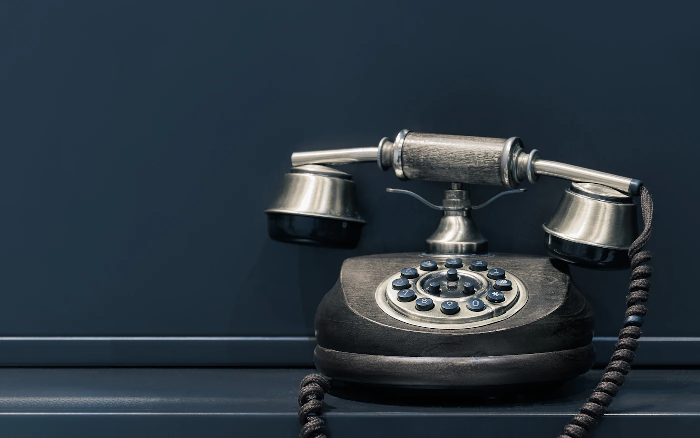 Vintage rotary telephone on a dark background